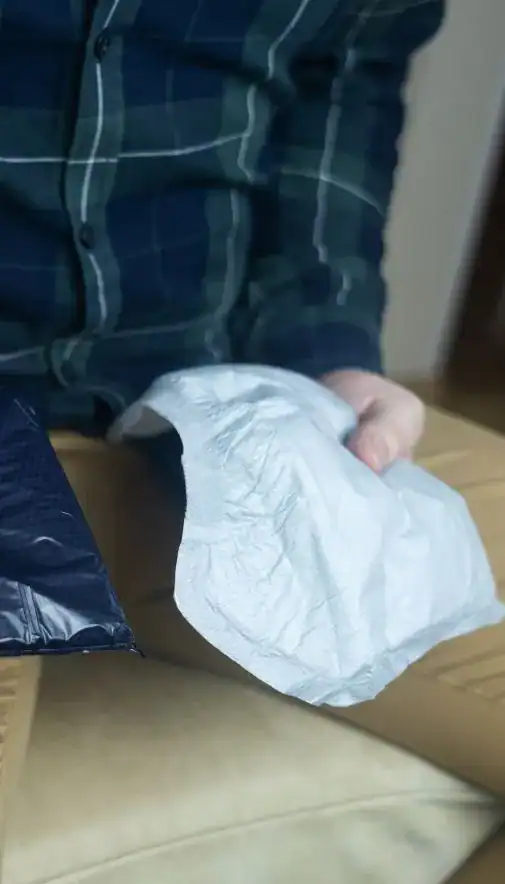 Image of man holding incontinence pads as part of overactive bladder treatment Oxford