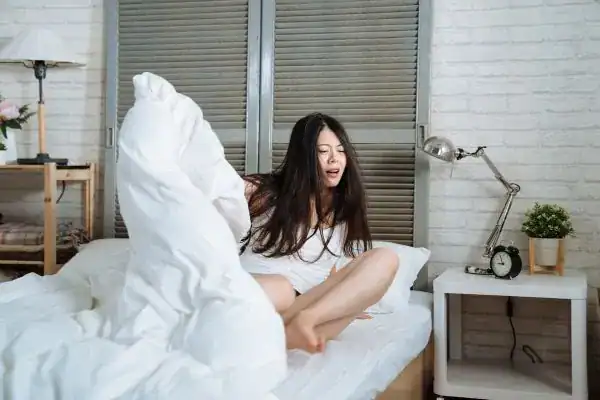 Image of woman getting up because of nighttime leaks Oxford